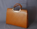 tan brief purse with detachable shoulder sling; zipper close