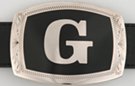 belt buckle with chrome initial "G" on black field