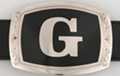 belt buckle with chrome initial "G" on black field
