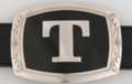belt buckle with chrome initial "T" on black field