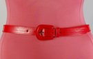 narrow red vinyl fashion belt with guitar-shaped buckle