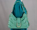 western hobo bag with antique brass horseshoe sewn to magnetic central flap; brass grommets in scalloped edge pieces
