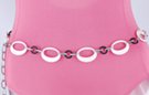 chain belt: white eccentric eggshell ovals alternate with black miniature rings, all joined by single stippled silver chain links which also form the extension chain tipped by another black ring