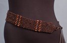checker-board mesh of spherical beads interspersed with rows of oblong beads, double twine tie on either end