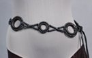 "hugs-n-kisses" bead belt; alternating 2" and 2-1/2" O's connected by X's; black ball-shaped beads, 4-strand synth leather ties